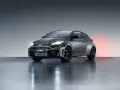 Szary Toyota GR Yaris GR-FOUR z agresywnym przednim zderzakiem i czarnymi felgami, gotowy do podboju dróg.