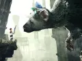 Chłopiec z piórem w ręku stoi na skale, patrząc na ogromnego stwora. Scena z gry The Last Guardian PS4.