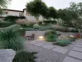 Giardino moderno con ghiaia, piante ornamentali e un piccolo tavolo. Idee giardino con ghiaia per un'oasi di pace.