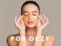Kobieta z zamkniętymi oczami delikatnie poprawia złote płatki pod oczami. Dowiedz się, jak nakładać płatki pod oczy dla promiennej skóry.