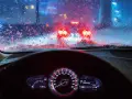 Cruscotto illuminato e parabrezza ghiacciato con luci rosse sfocate di altre auto. Si guida di notte in condizioni difficili.