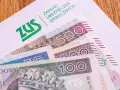 Kiedy trzynasta emerytura, ZUS przekazuje pieniądze. Widoczne banknoty 100, 200 i 500 zł.