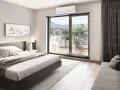 Unidad exterior de aire acondicionado visible a través de la puerta corredera, con una cama y arte de pared en la habitación.