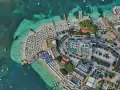 Albania najpiękniejsze miejsca: tętniący życiem kurort plażowy z białymi parasolami, turkusową wodą i basenami.