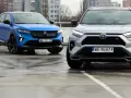 Niebieski i srebrny SUV, jedne z najlepszych aut, stoją na mokrym parkingu.