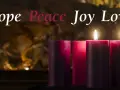 Three lit candles, representing the second week of Advent, glow with "Hope, Peace, Joy, Love" in elegant script.