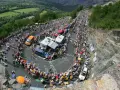 Spectators line the winding road of Alpe d'Huez for the Tour de France, a sea of color and anticipation.