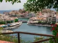 Malowniczy widok na port w Agios Nikolaos na Krecie. Woda lśni, a nadbrzeże tętni życiem.