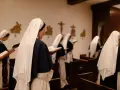Nuns in a chapel reading from books. This scene offers a glimpse into how to join a monastery female, showcasing devotion and study.