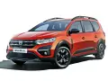 Pomarańczowy Dacia Jogger, marka samochodu na d, z relingami dachowymi i czarnymi felgami.
