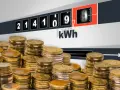 Stosy monet i licznik energii wskazujący zużycie kWh. Zastanawiasz się, ile kosztuje 1 kWh Tauron?