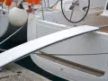 Eine selbstgebaute Gangway für Boote, die über eine Reling gelegt wird.