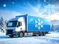 Biała ciężarówka z niebieską naczepą i symbolem płatka śniegu, gotowa do transportu chłodniczego przez zimowy krajobraz.