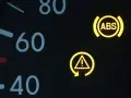 Armaturenbrett mit leuchtenden Warnleuchten: ABS und ESP-Symbol. Die ESP auto bedeutung ist, dass das elektronische Stabilitätsprogramm aktiv ist oder eine Störung vorliegt.