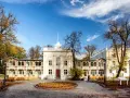 Brzeźno dom zdrojowy, zabytkowy budynek z arkadowymi werandami, otoczony jesiennym parkiem.