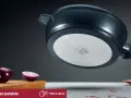 Patelnia żeliwna z metalowym dnem, obok czerwonej cebuli na desce.