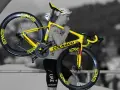 A cyclist carries his bright yellow Colnago bike, ready for Tour de France training.