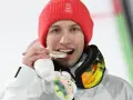 Kacper Tomasiak z medalem, który z dumą pokazują jego rodzice.