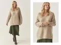Modelka w beżowym swetrze w stylu oversize i zielonej spódnicy.
