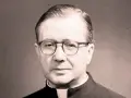 Portrait of a man in clerical attire, wearing glasses. His thoughtful gaze suggests an opus work of God, a life dedicated to faith and service.