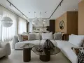 Nowoczesny projekt mieszkania z białą sofą, okrągłymi stolikami i designerskimi lampami.