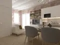Arredare monolocale con stile: divano bianco, cucina moderna, mattoni a vista e tavolo da pranzo.