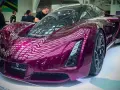 A stunning purple concept car, showcasing the future of automotive 3d printing with its sleek, futuristic design.