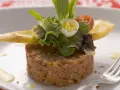 Un délicieux tartare de bœuf, garni d'une salade fraîche, d'un œuf de caille et de croûtons. Une recette parfaite pour un repas raffiné.