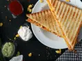 Grillowane tosty z kukurydzą i serem, podane z sosami. Oto co można zrobić w opiekaczu grillowym!