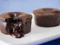 Fondant au chocolat coulant, une gourmandise inspirée de la recette de Cyril Lignac. Le cœur liquide de chocolat fond sur la plaque blanche.
