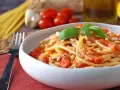 Spaghetti con pomodorini, pinoli e basilico, un'idea per sughi estivi per pasta freschi e veloci.
