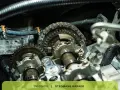 Close-up of car engine timing chain and gears. This could be related to a p0017 code issue.