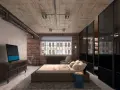 Camera da letto in stile industrial chic con pareti in mattoni, soffitto in cemento a vista e armadio con ante in vetro.