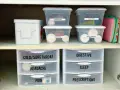 Organized medicine cabinet with labeled bins and drawers for easy access to medications and first-aid supplies.