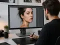 Un homme retouche un portrait sur Photoshop, utilisant un outil fluidité pour peaufiner les détails du visage.