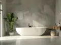 Bagni in resina idee: vasca freestanding bianca, piante verdi, lavabo in pietra e finiture in cemento per un look moderno e rilassante.