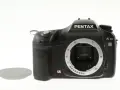 Czarny aparat Pentax K10 z widocznym mocowaniem obiektywu i osłoną. Wewnątrz widoczny jest sensor ccd.