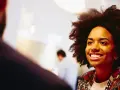 Donna sorridente in un colloquio, pensando a che lavoro fare a 40 anni senza esperienza.