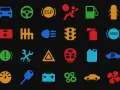 Icone colorate su sfondo nero: cruscotto auto, cambio, spie motore benzina, ABS, batteria, ruote, ecc.
