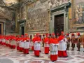Cardinals in red robes process through a grand hall, a scene hinting at how the Pope is chosen through conclave.