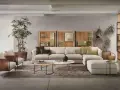 Un salotto moderno con divano componibile color tortora, poltrone in vimini e piante verdi.