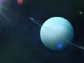 Błękitny Uran z pierścieniami na tle kosmosu, gdzieś w gwiazdozbiorze Byka.