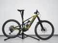 A gold Polygon mullet bike with a dropper post, full suspension, and knobby tires, ready for any trail.
