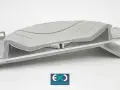 A complex, layered component showcasing advanced forming plastics, with a subtle wave pattern on the top surface.
