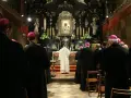 Uroczyste msze święte na Jasnej Górze. Biskupi w czarnych szatach i różowych biretach modlą się przed ołtarzem z cudownym obrazem Matki Bożej.