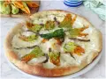 Pizza con fiori di zucca, mozzarella filante e acciughe. Un sapore delicato e profumato, perfetto per l'estate.
