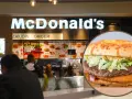 Zbliżenie na burgera McDonald's na tle wnętrza restauracji z menu.