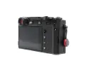 Czarne body aparatu Fujifilm X100S z widocznym ekranem, przyciskami i uchwytem na pasek.