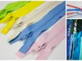 Curseurs de fermeture éclair de différentes couleurs et tailles, prêts à être utilisés.