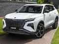 Nowy, biały chinski suv z imponującym grillem i felgami stoi na podjeździe.